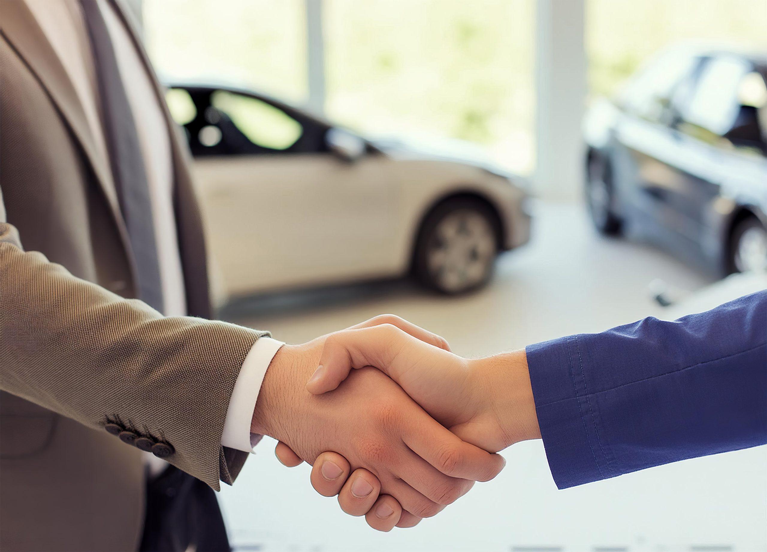 Close up of handshake in the car dealership offices